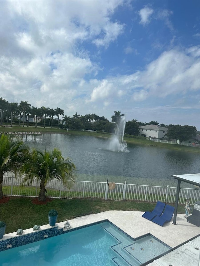 view of swimming pool with a water view and a patio