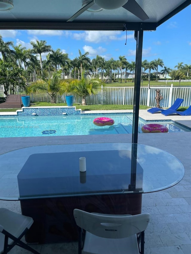 view of pool featuring ceiling fan and a patio