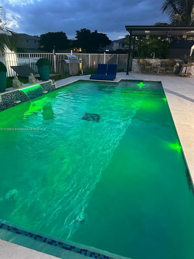 pool at dusk with a patio