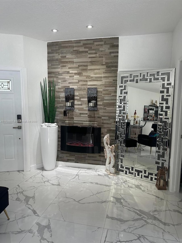 living room featuring a tiled fireplace