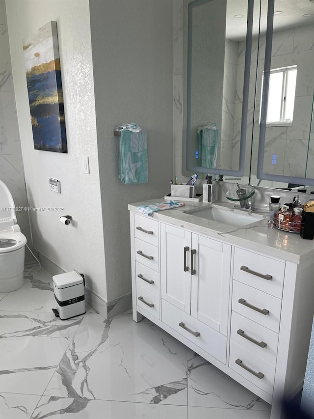 bathroom featuring toilet and vanity