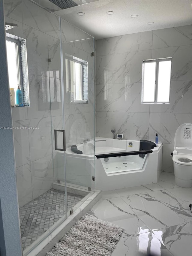 bathroom featuring tile walls, toilet, and walk in shower