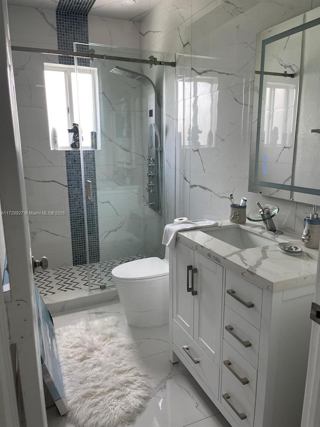 bathroom with toilet, a shower with door, and vanity