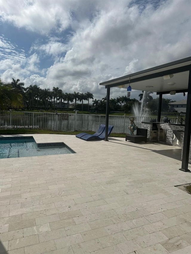 view of swimming pool with a bar and a patio