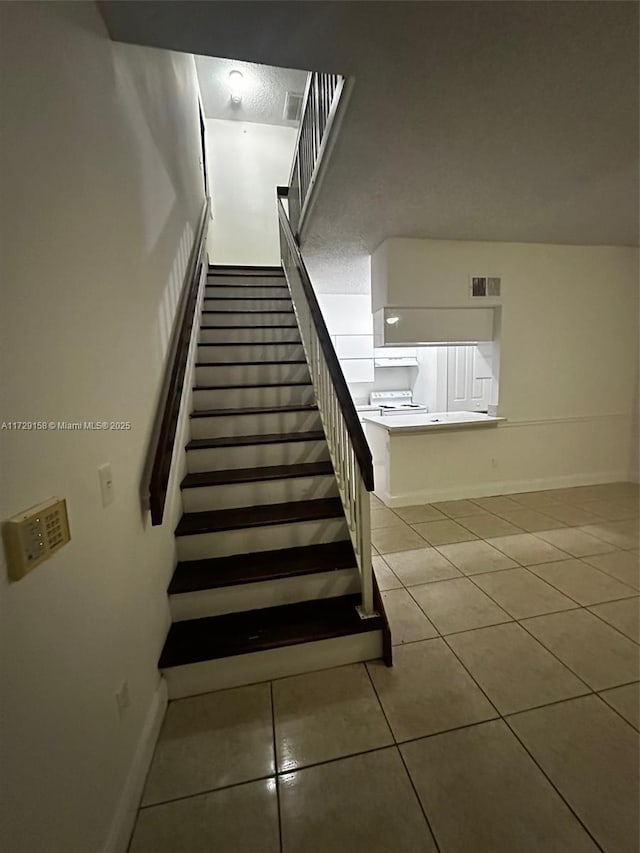 stairway with tile patterned flooring