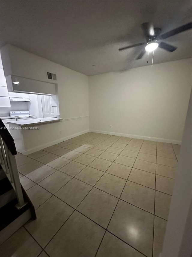 spare room featuring ceiling fan and light tile patterned floors