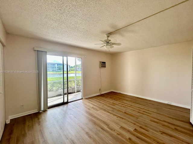 empty room with a textured ceiling, ceiling fan, and hardwood / wood-style flooring