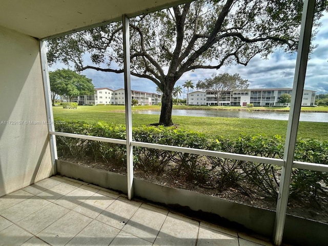 unfurnished sunroom with a water view