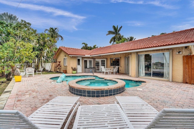 view of swimming pool with an in ground hot tub and a patio area