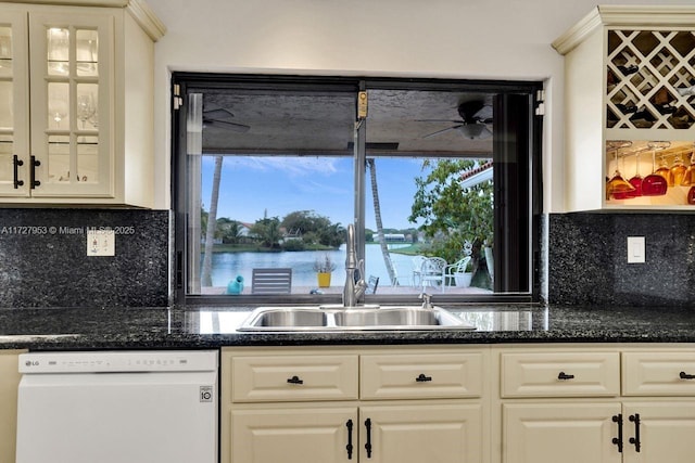 kitchen featuring dishwasher, white cabinetry, tasteful backsplash, sink, and a water view