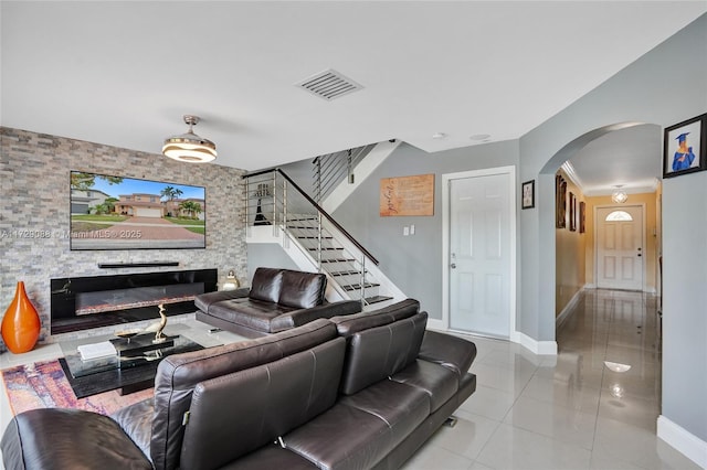 living room featuring light tile patterned floors and a fireplace