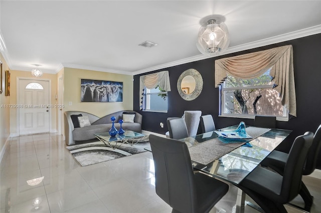 dining area featuring light tile patterned floors and crown molding