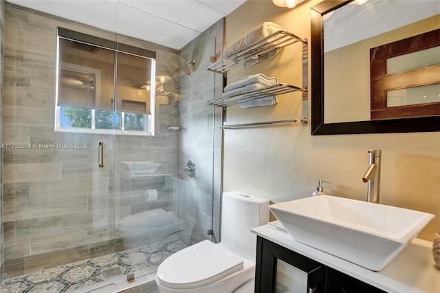 bathroom with an enclosed shower, vanity, and toilet