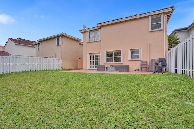 back of property featuring a patio area, outdoor lounge area, and a yard