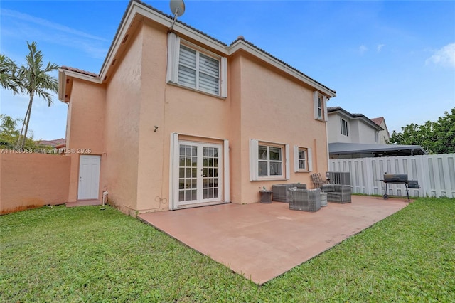 back of property featuring an outdoor living space, a patio area, french doors, and a yard