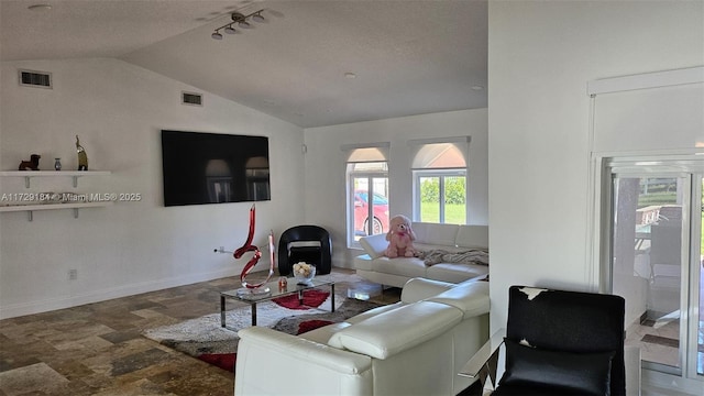16400 SW 173rd Ave, Miami, FL 33187 - living area featuring vaulted ceiling, stone finish floors, baseboards, and a wood stove