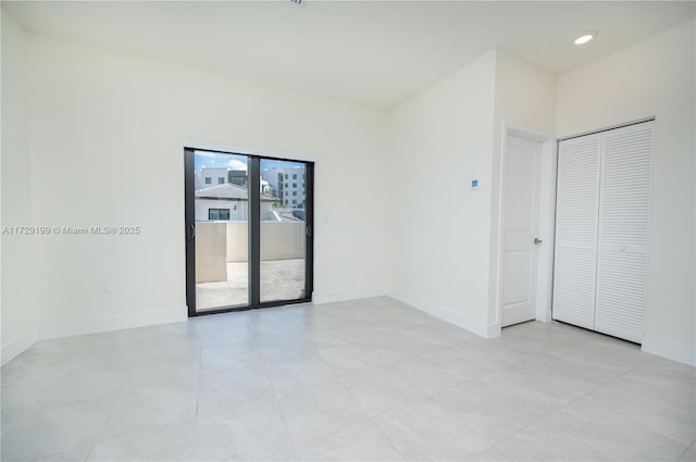 empty room with recessed lighting and baseboards