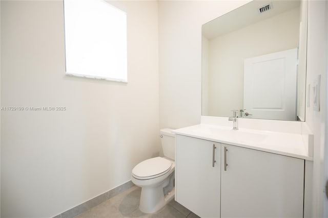 half bathroom featuring visible vents, toilet, vanity, tile patterned flooring, and baseboards