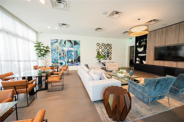 living room featuring light wood-style floors and visible vents