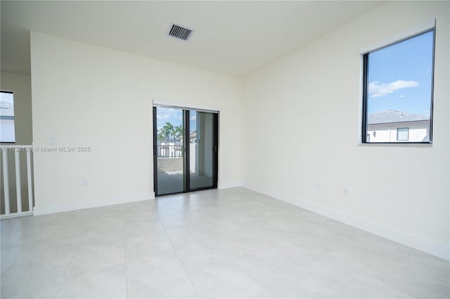 empty room with visible vents and baseboards