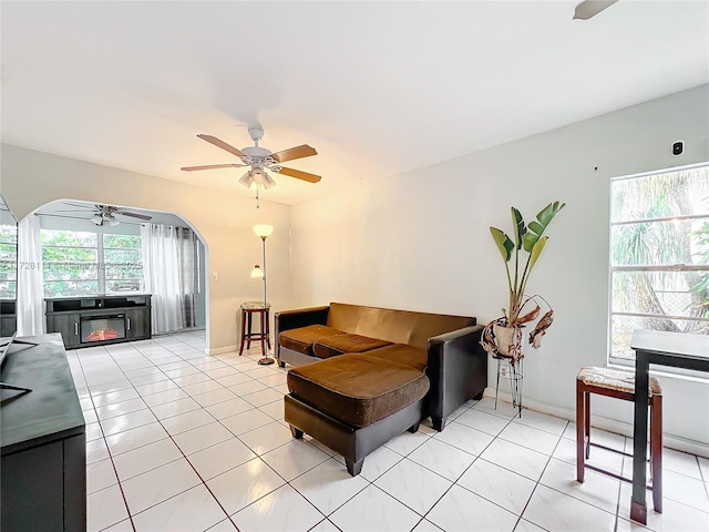 tiled living room featuring ceiling fan