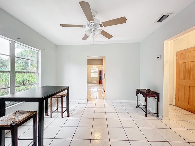 dining area with light tile patterned floors and ceiling fan