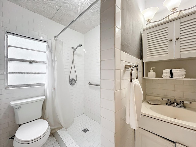 bathroom featuring tile patterned flooring, vanity, walk in shower, toilet, and a textured ceiling