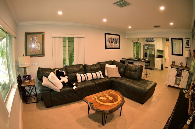 tiled living room featuring crown molding