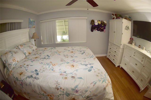 bedroom with ceiling fan, ornamental molding, and light wood-type flooring