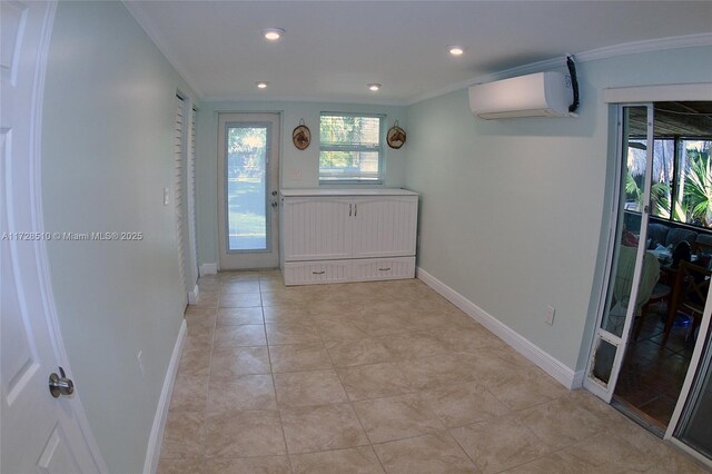 doorway to outside with crown molding, a wall mounted air conditioner, and light tile patterned floors