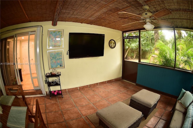 sunroom / solarium featuring brick ceiling, vaulted ceiling, and ceiling fan