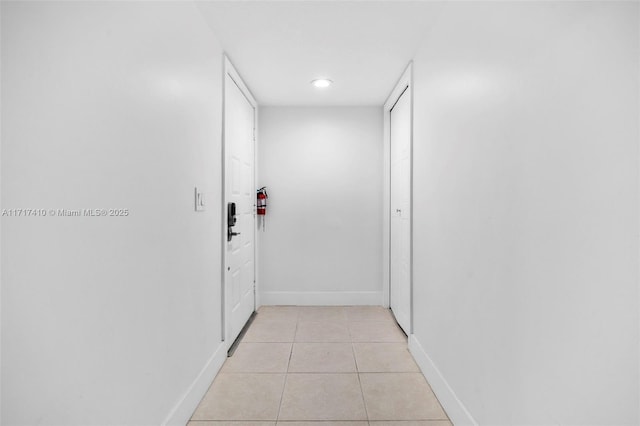 hallway featuring light tile patterned floors