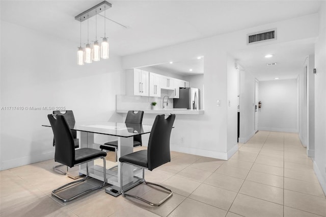 dining area with light tile patterned floors and sink