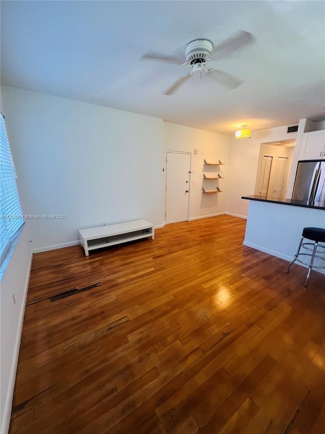 1523 W Ave Unit 101, Miami Beach, FL 33139 - unfurnished living room with wood finished floors, ceiling fan, and baseboards