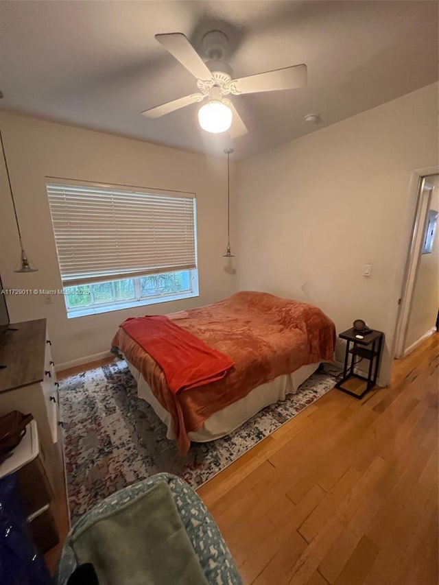 bedroom with ceiling fan and light hardwood / wood-style floors