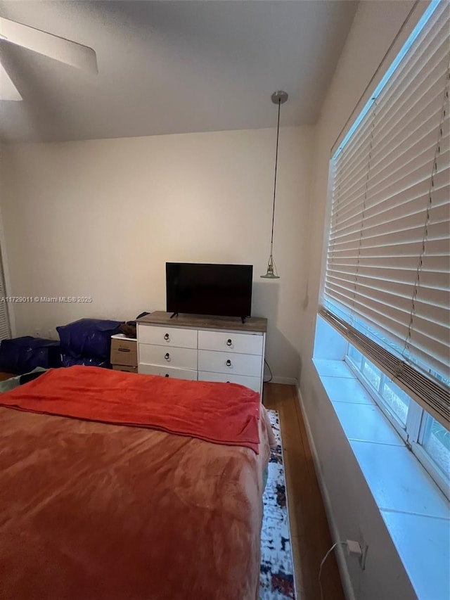 bedroom featuring ceiling fan and hardwood / wood-style floors