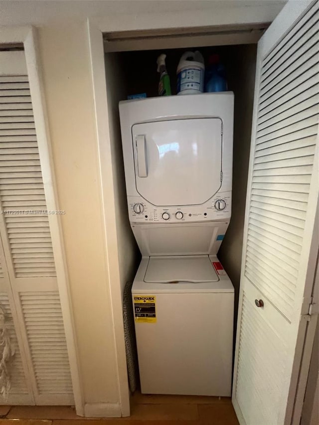 laundry room featuring stacked washer / drying machine