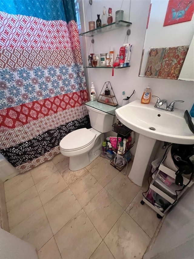 bathroom with toilet and tile patterned flooring