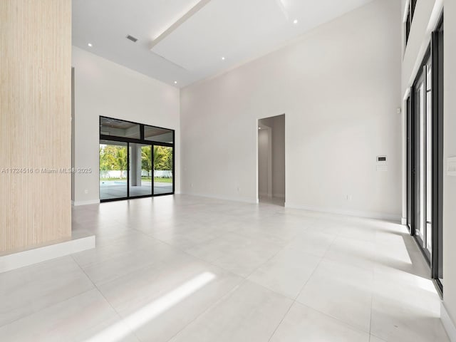 unfurnished room with a towering ceiling