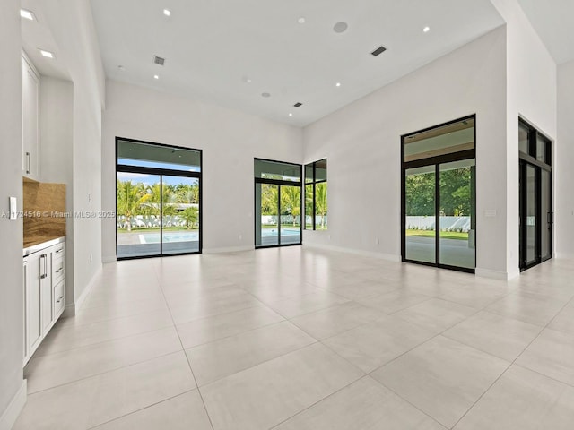 tiled empty room with a high ceiling