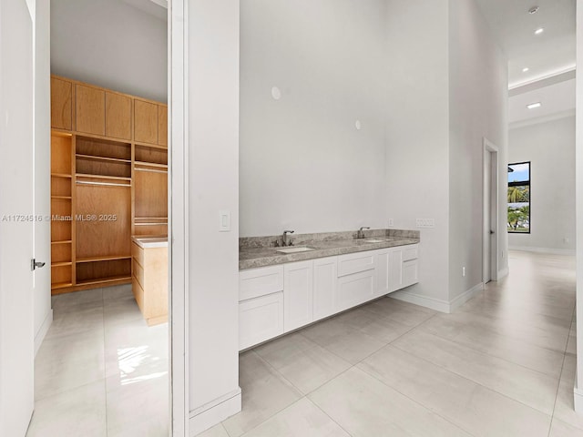 bathroom featuring tile patterned flooring and vanity