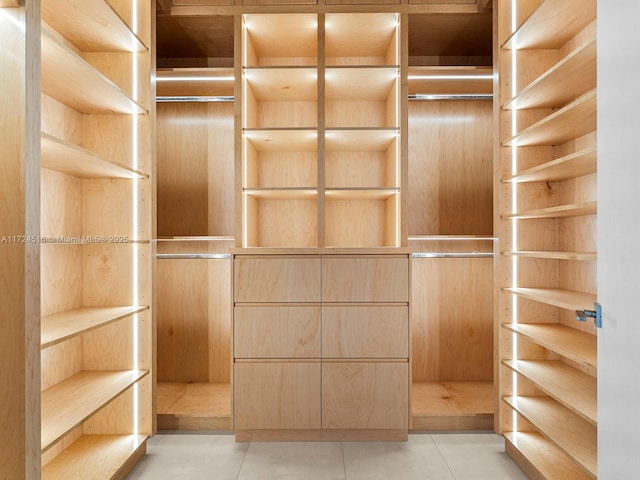 spacious closet featuring light tile patterned flooring