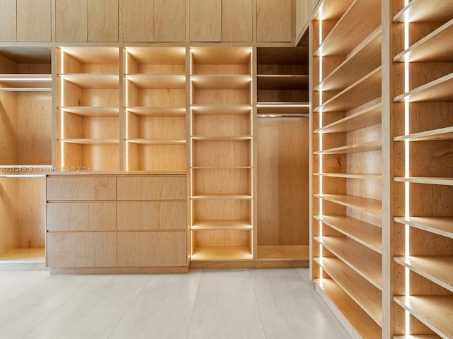 walk in closet with tile patterned floors