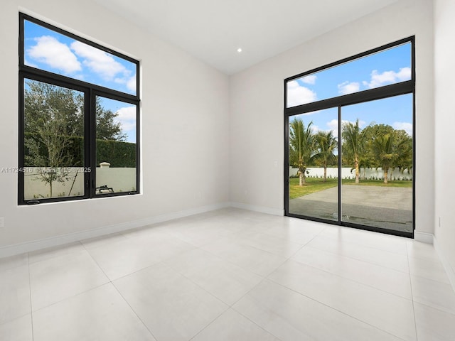 spare room with a healthy amount of sunlight and light tile patterned floors