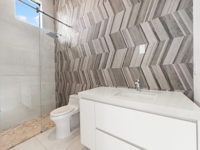 bathroom featuring an enclosed shower, vanity, tile patterned flooring, and toilet