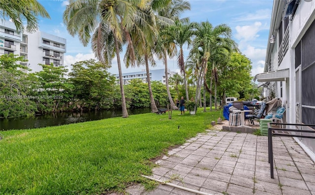 view of yard featuring a patio and a water view