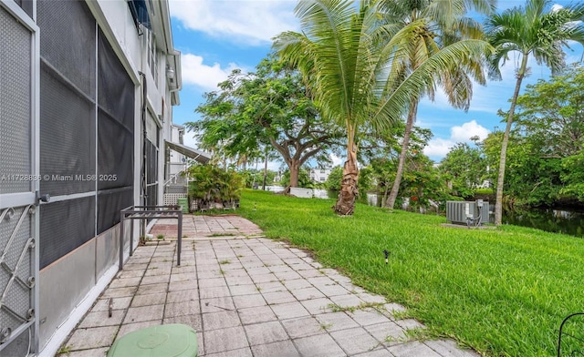 view of yard featuring cooling unit and a patio