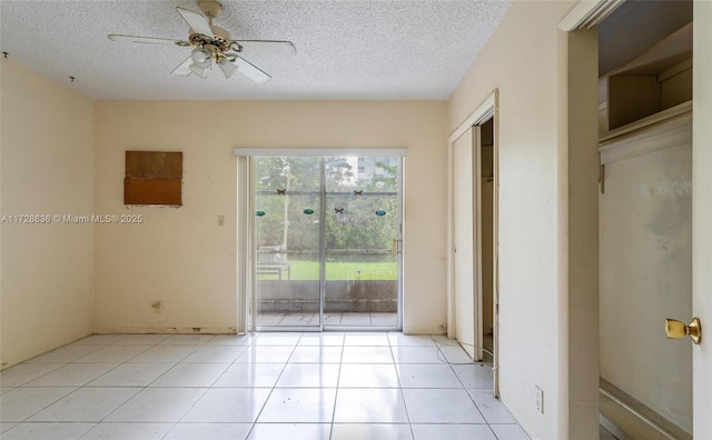 tiled empty room with a textured ceiling and ceiling fan