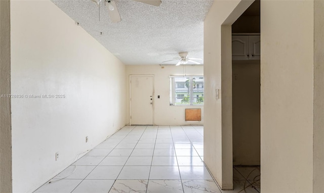 spare room featuring a textured ceiling and ceiling fan