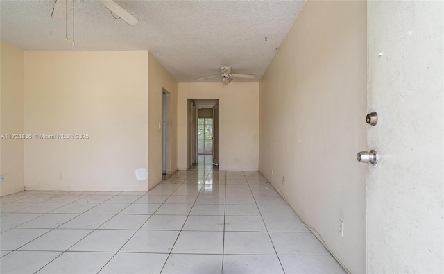 hallway featuring light tile patterned floors and a textured ceiling